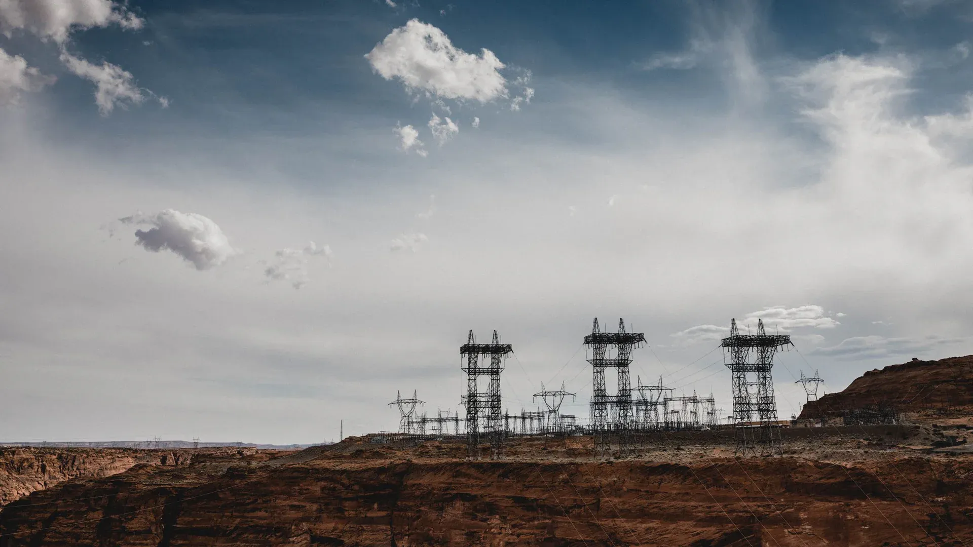 High-voltage power lines stretch across the desert landscape at North Rim, Arizona