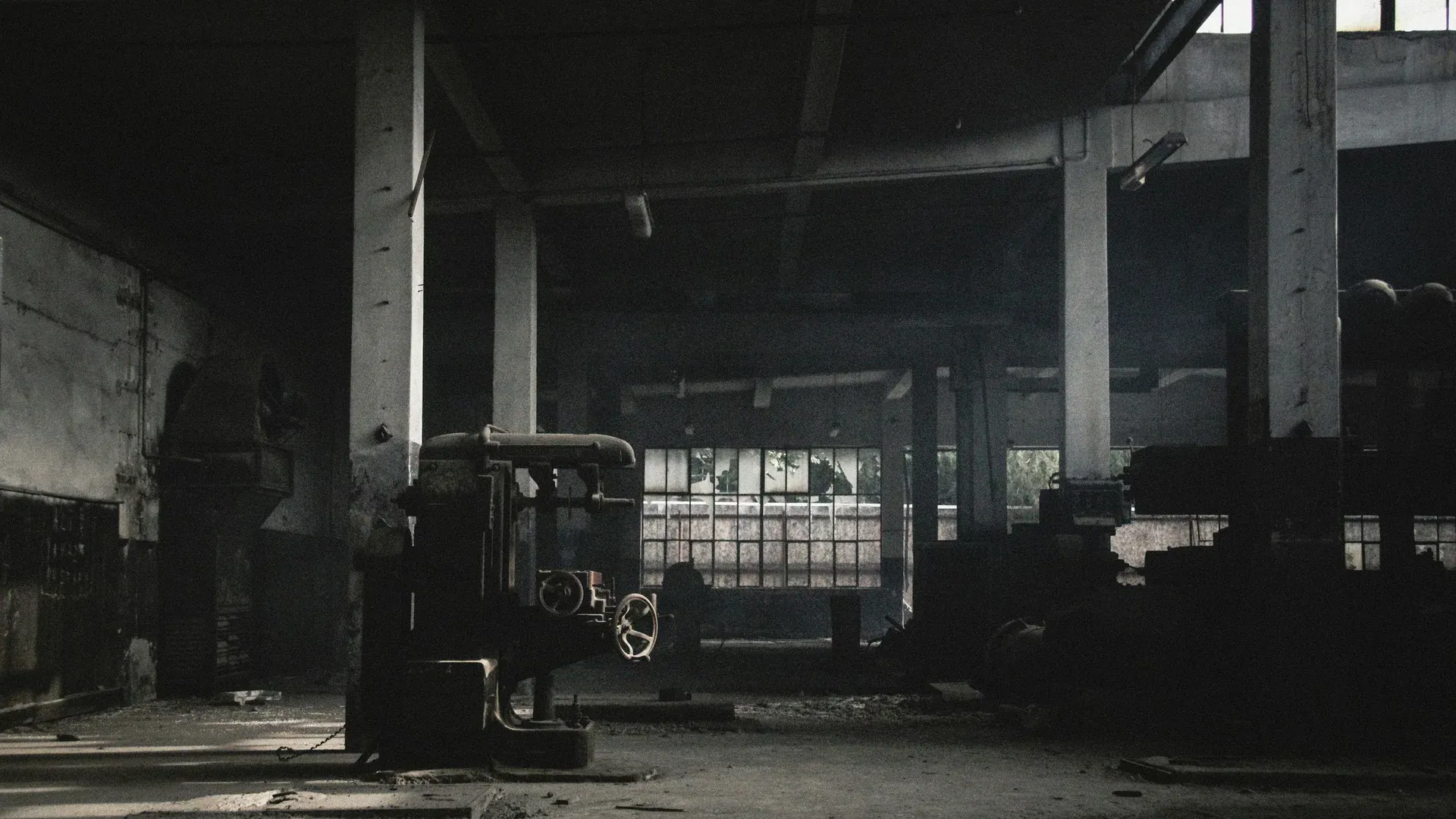 Dimly lit abandoned warehouse with machinery in Kayseri, Turkey