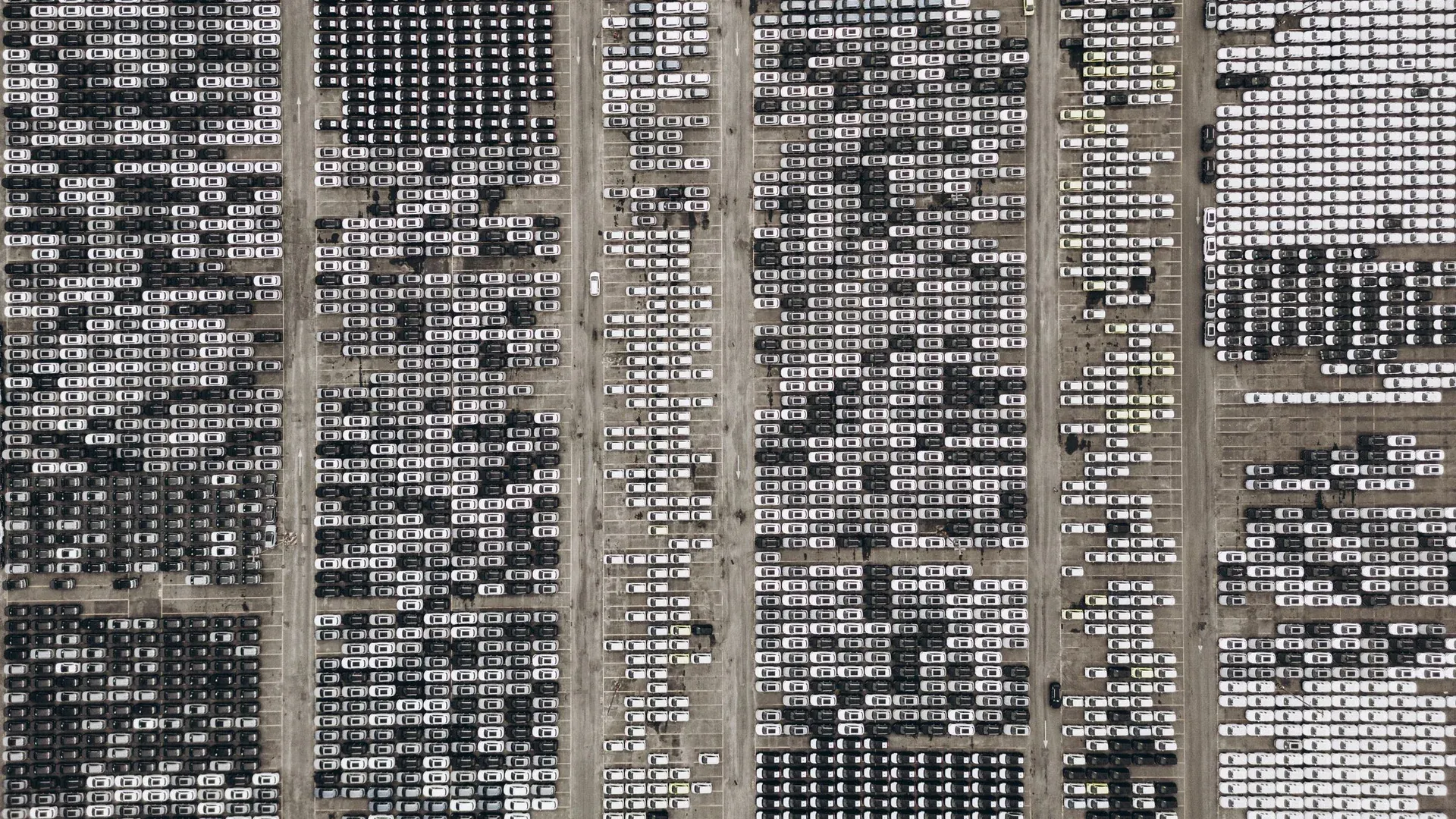 High-angle aerial shot of a massive car parking area, filled with vehicles in Brazil