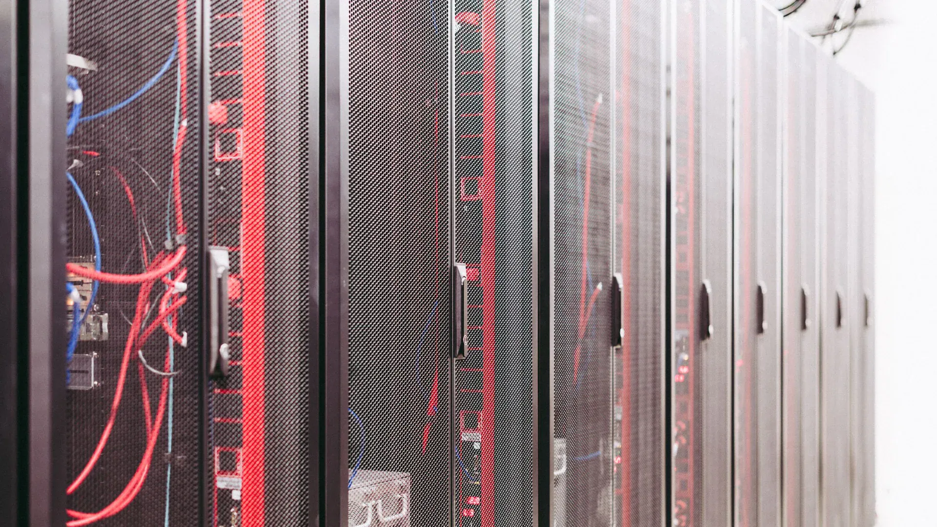 Server racks and structured cabling inside a data center aisle