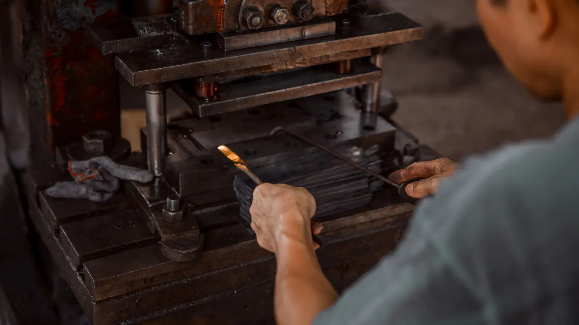 Operator using an industrial press for metalworking