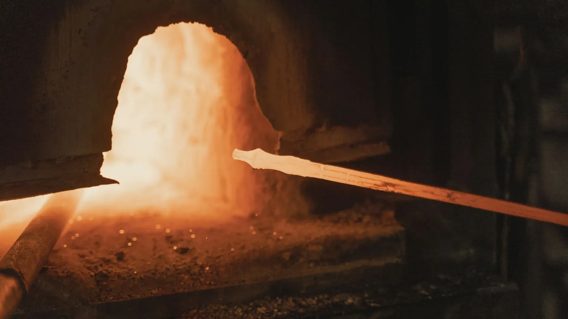Orange-hot metal visible through the opening of an industrial furnace