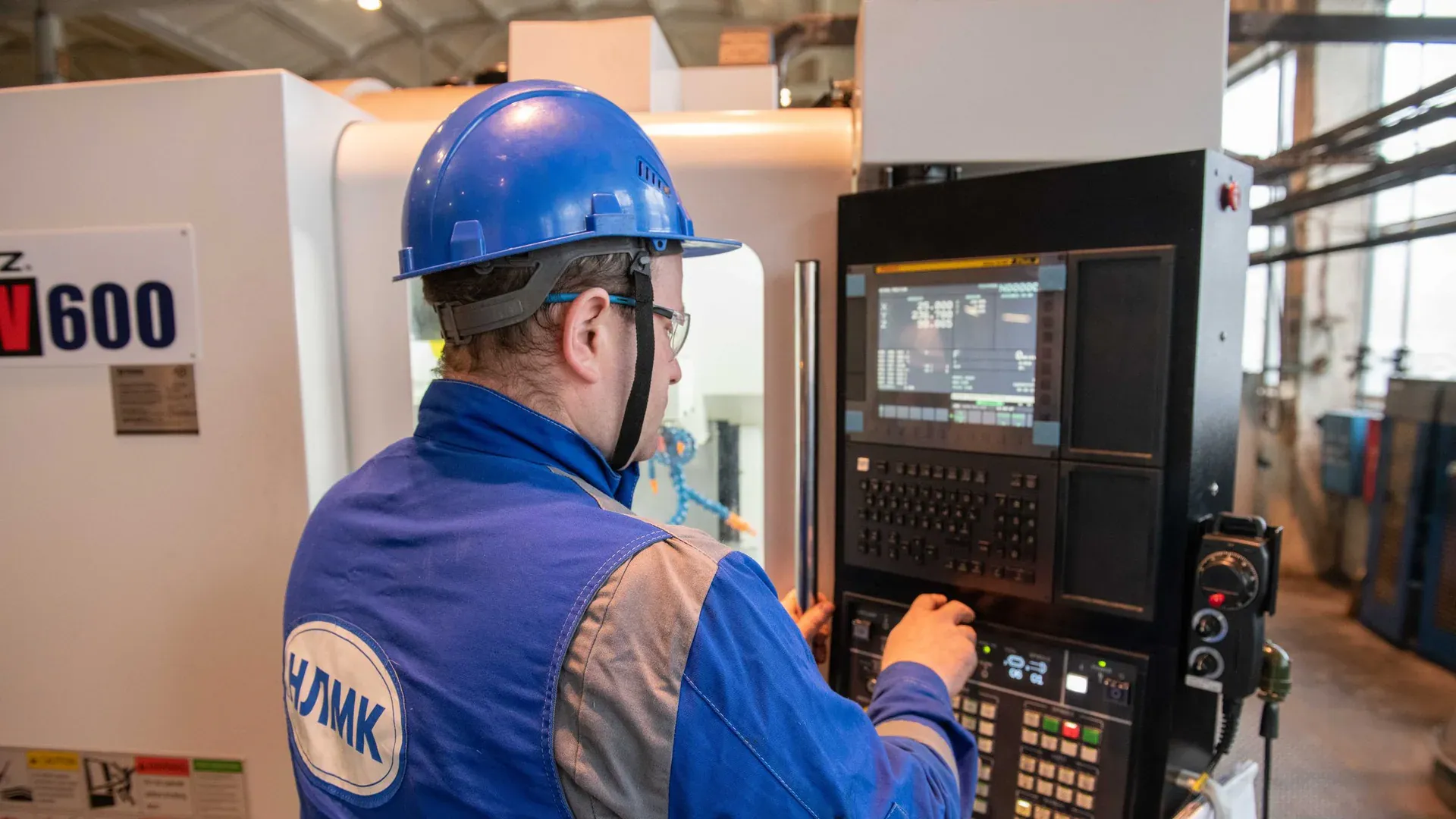 Machine operator working at a CNC control during a production time study