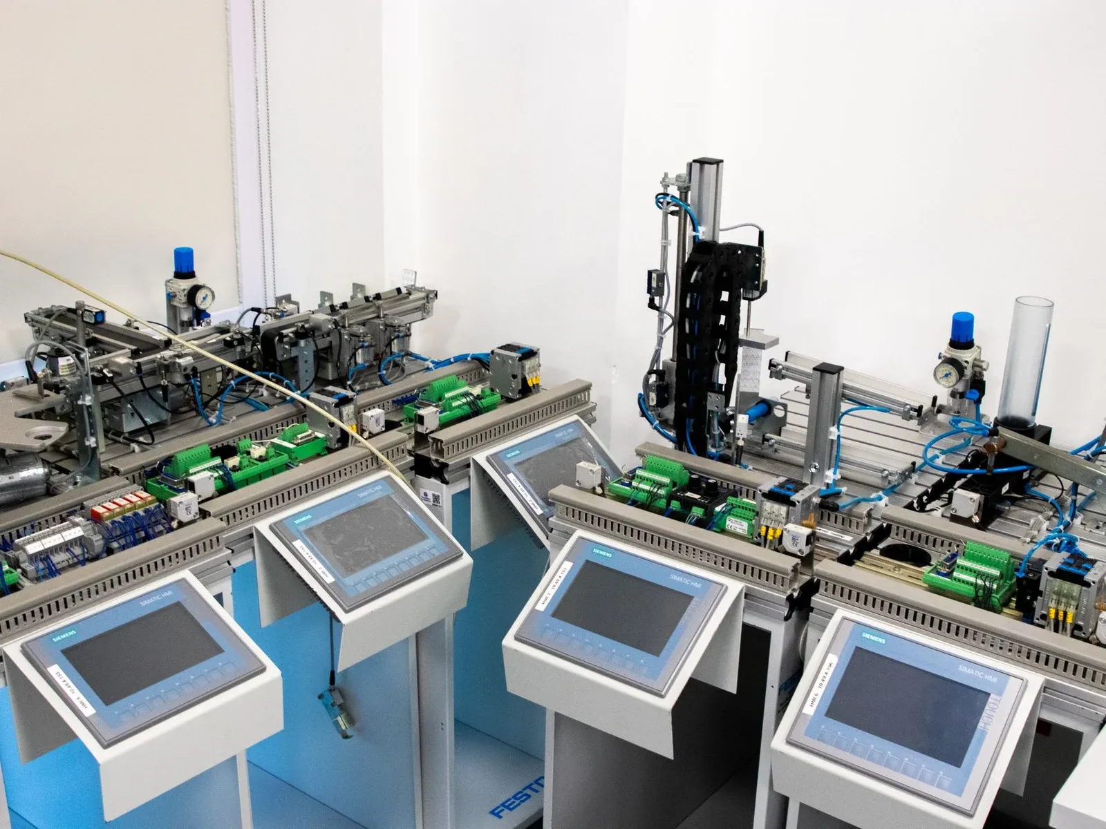 Automated industrial workstations with operator screens and material tracks