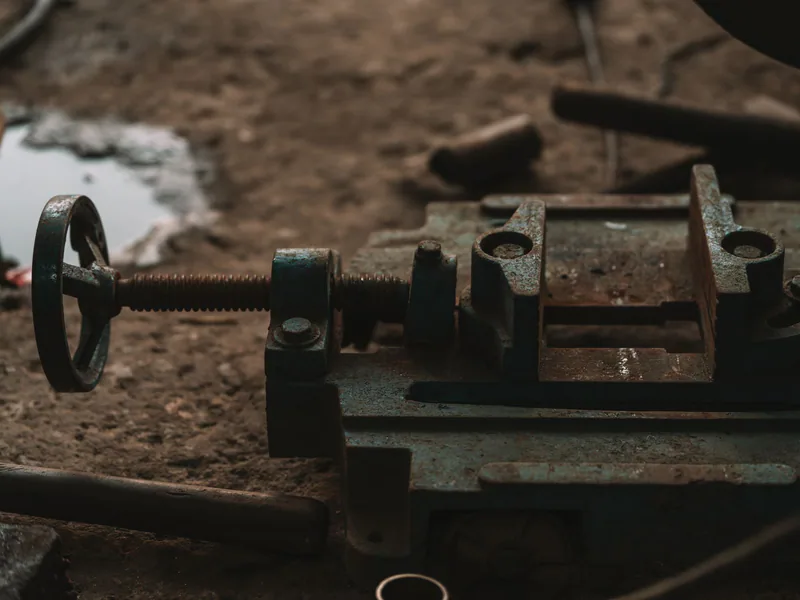 Close-up of rusty industrial tools in a workshop setting, emphasizing craftsmanship