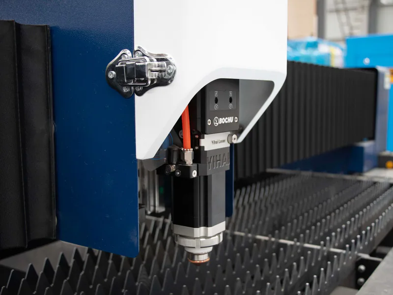 Detailed view of a precision industrial laser cutter in a manufacturing environment