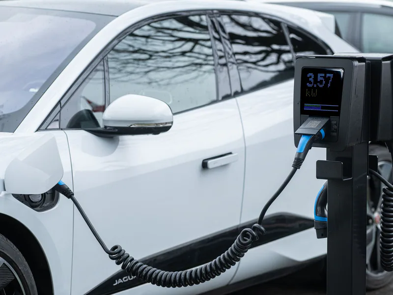 Close-up of an electric vehicle charging at a station, showcasing energy-efficient technology