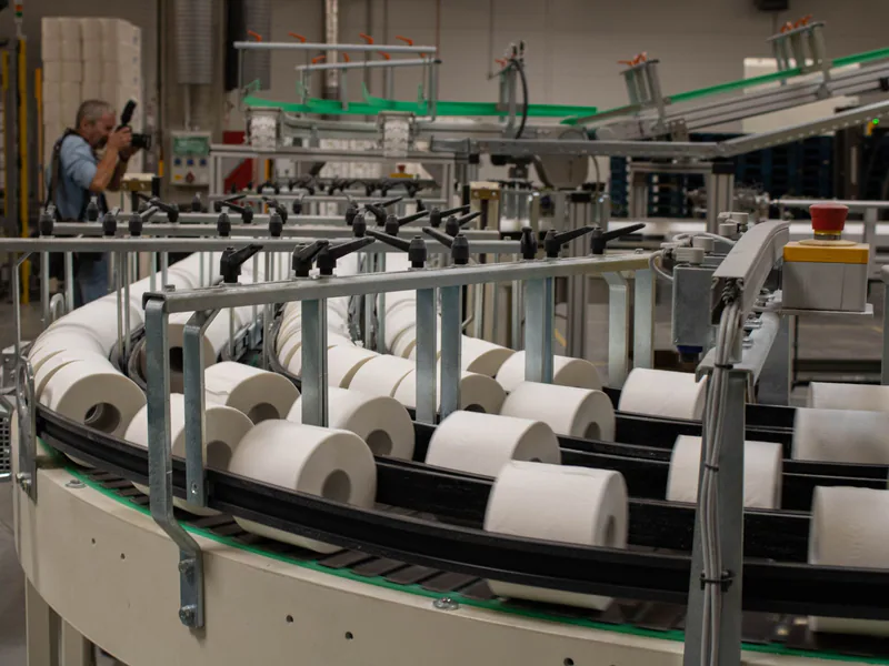 A production line for toilet paper in an industrial setting