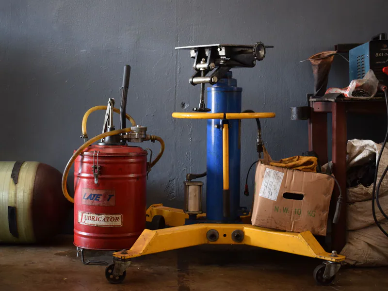 A well-equipped workshop features various machinery and an industrial lubricator