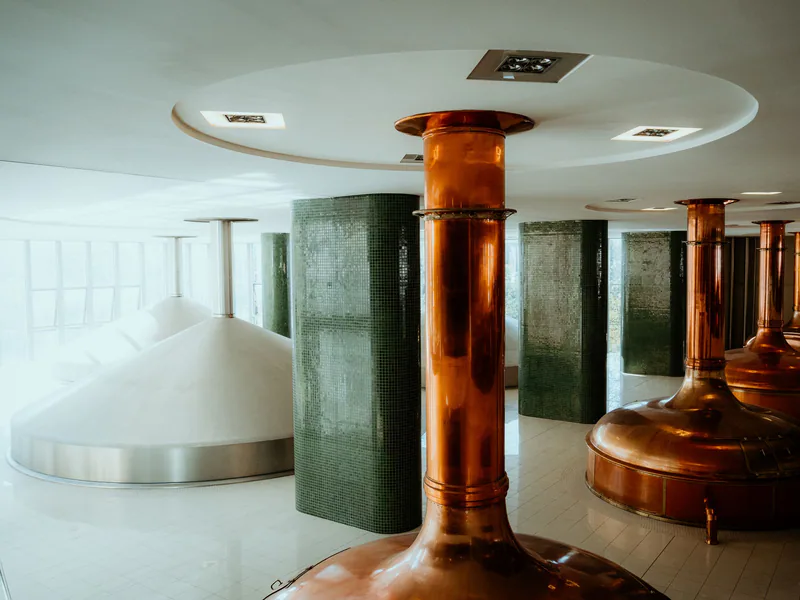 Interior view of a brewery in Pilsen, showcasing copper tanks and modern design