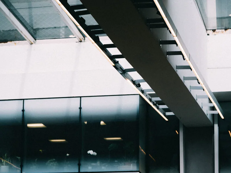 Modern architectural detail showcasing a bridge with glass facade and sleek design