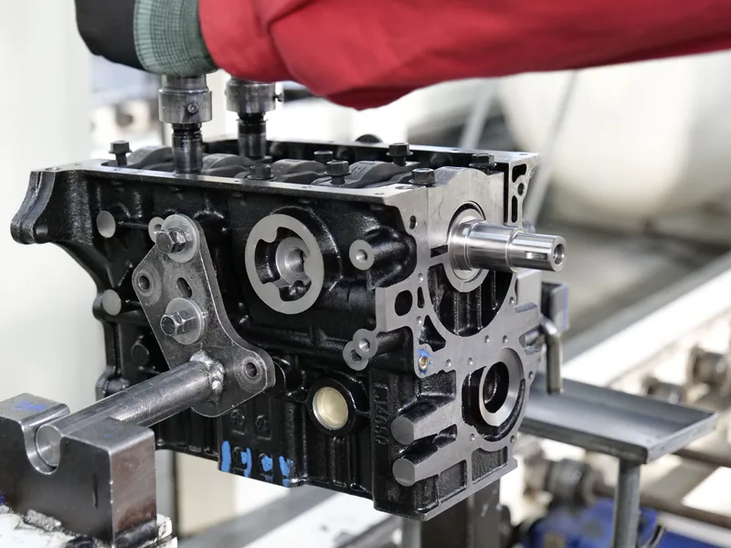 Close-up of engine assembly process highlighting industrial precision