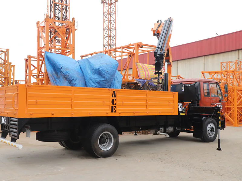 Orange truck with crane at construction site in Faridabad, India