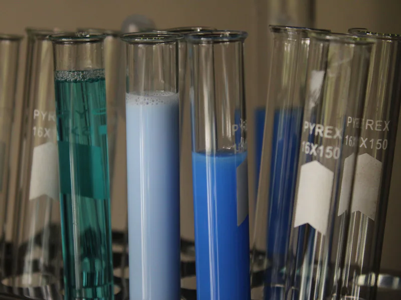 Close-up of colorful chemical solutions in glass test tubes in a laboratory setting