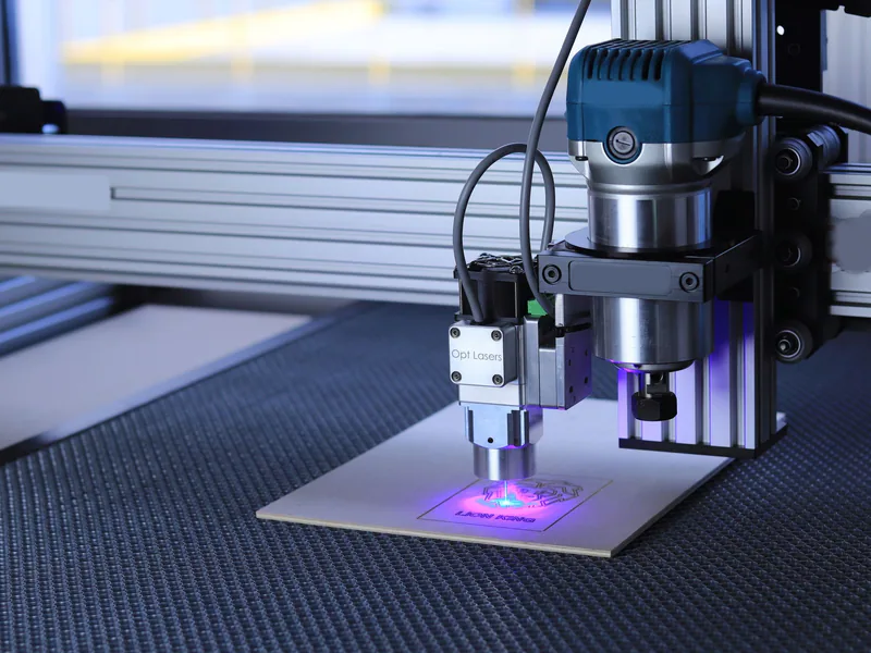 Close-up of a laser cutting machine engraving a design on metal using advanced technology