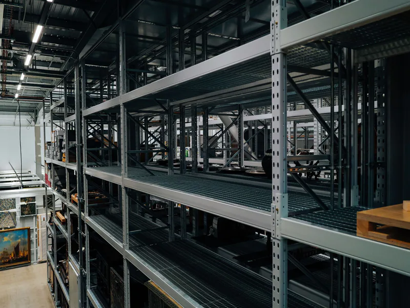 Empty metal storage racks in a spacious industrial warehouse setting