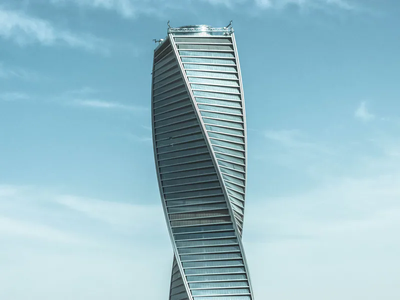Majdoul Tower spirals into a blue sky, showcasing modern architecture in Riyadh