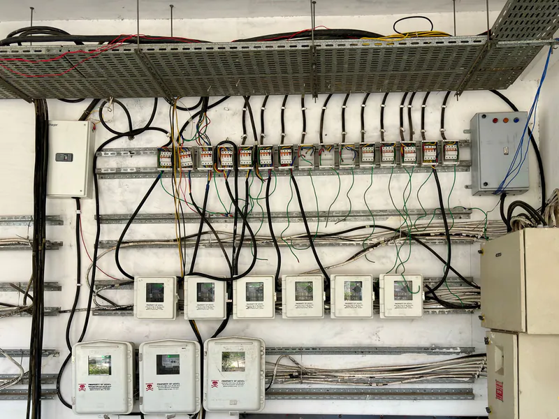 Electrical control cabinet with exposed wiring and protection devices