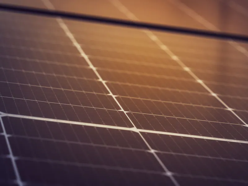 Close-up of conductive ribbons across photovoltaic solar cells