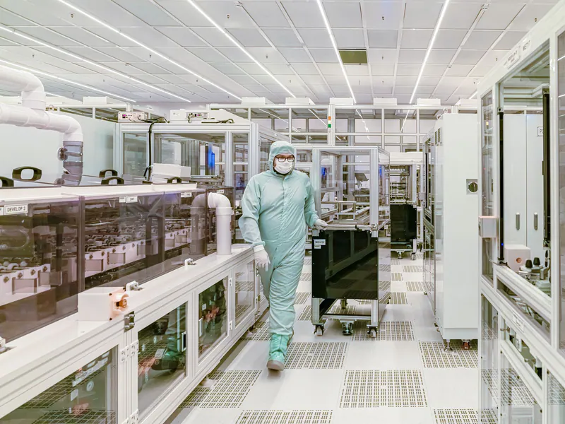 Technician inside a cleanroom solar-cell production line