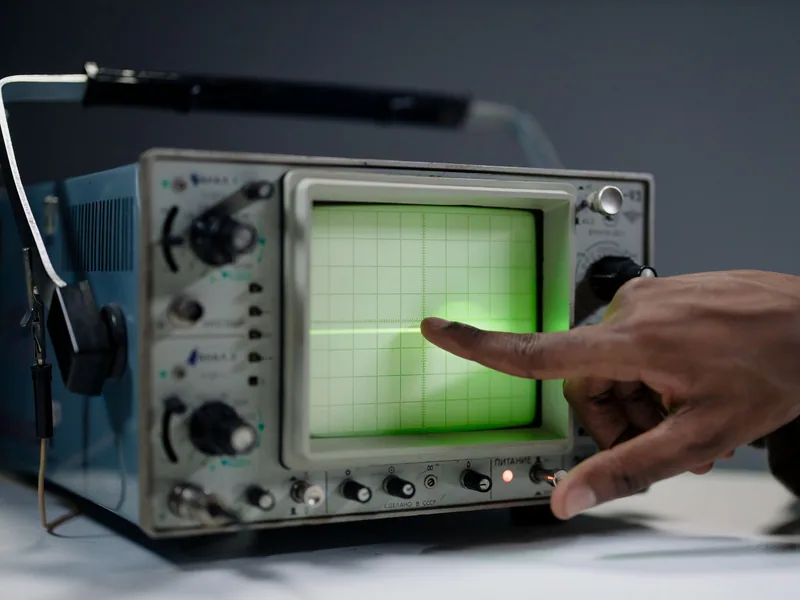 Analog oscilloscope displaying a waveform during electrical testing