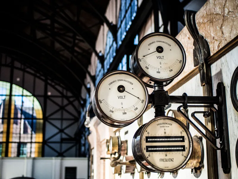 Vintage electrical meters displaying voltage, current, and power scales
