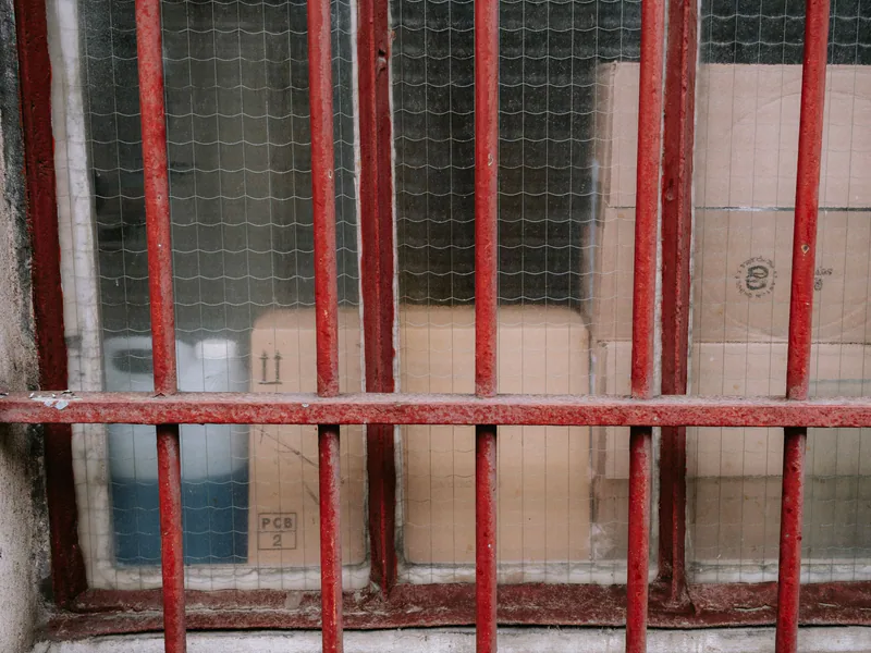 Cardboard boxes protected behind a metal warehouse barrier