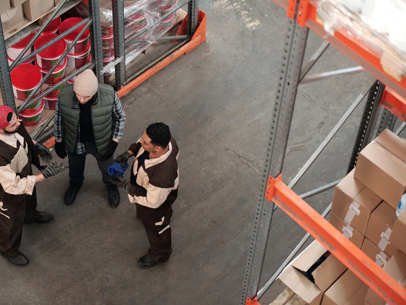 Warehouse staff reviewing packaged freight from an elevated viewpoint