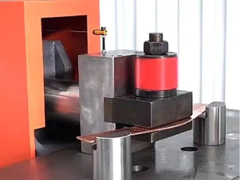 Steel bending tools installed on a busbar machine bed