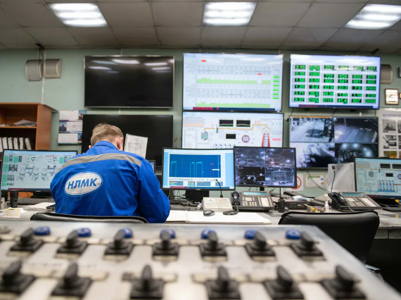 Industrial control room monitors displaying production performance