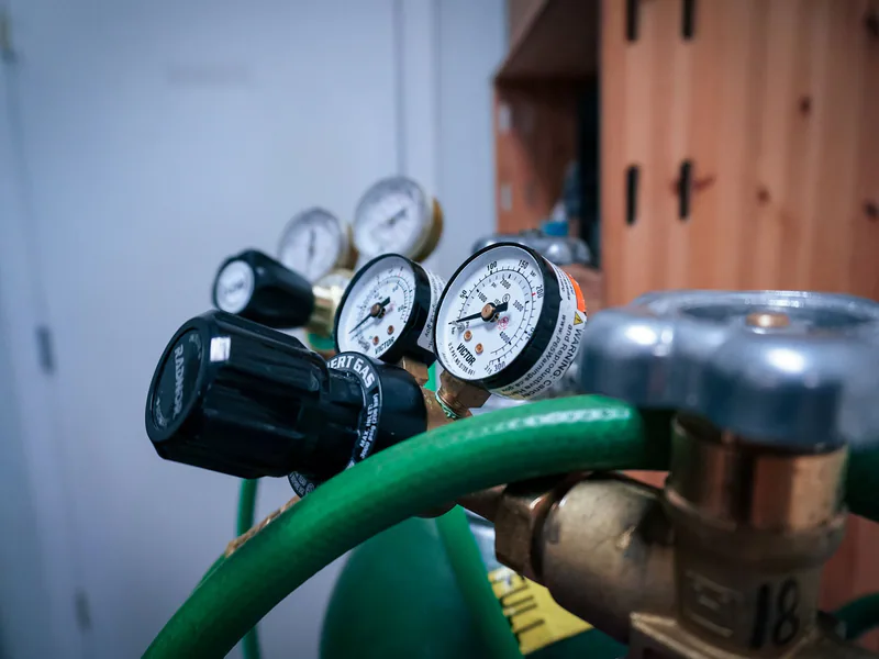 Pressure gauges and hoses inspected on an industrial fluid-power system