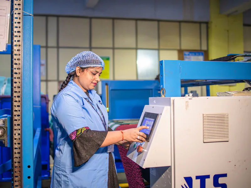 Factory technician documenting industrial equipment commissioning
