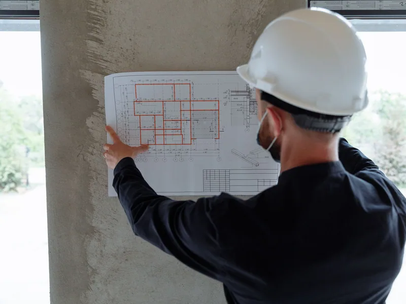 Engineer reviewing controlled technical drawings during an equipment inspection