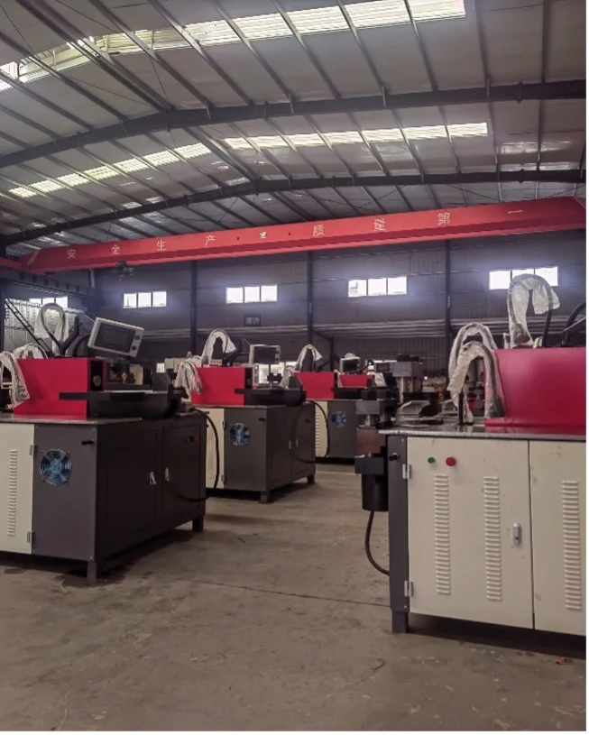 Row of CNC busbar processing machines on an assembly workshop floor ready for delivery